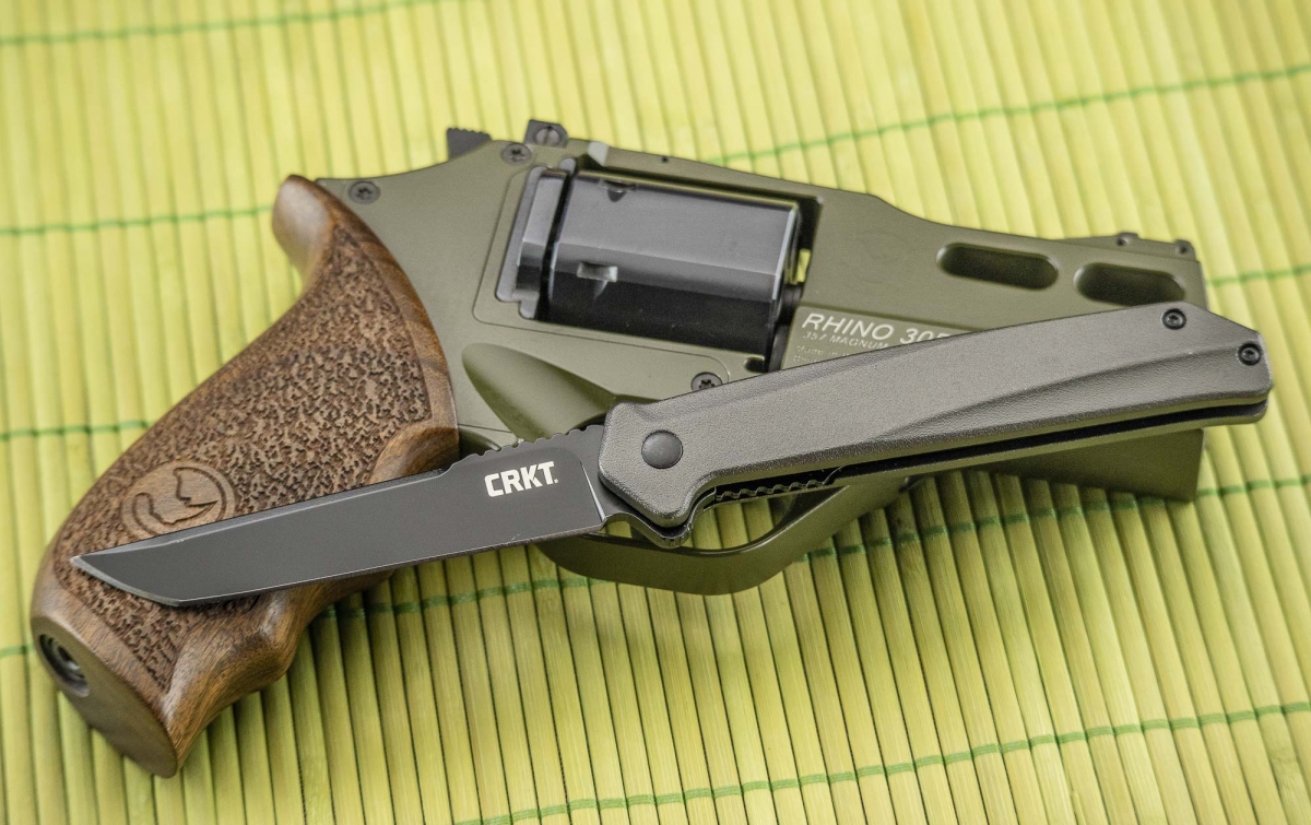 The CRKT Helical Black folding knife, pictured with a Chiappa Firearms Rhino &quot;Hunter&quot; revolver 