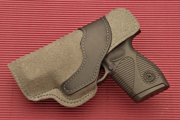A polymer liner wraps both sides of the holster