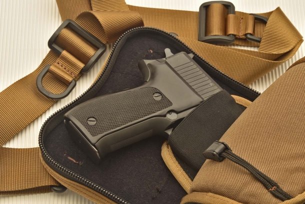A full-size SIG Sauer P226 pistol in the internal holster