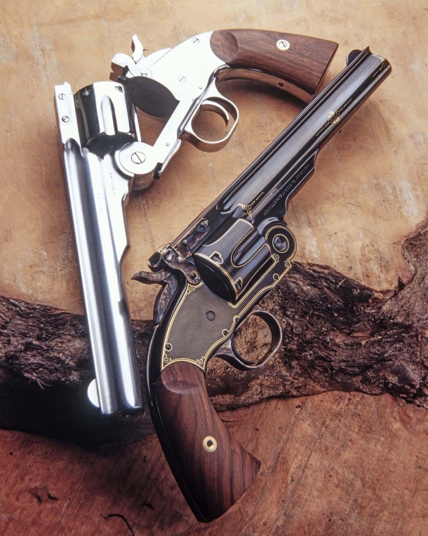 Two beautiful Schofield replicas by Uberti, one polished stainless, the other an elegantly engraved "presentation grade" blued specimen.