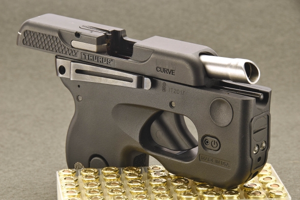 The slide of the Taurus 180 Curve pistol, held open