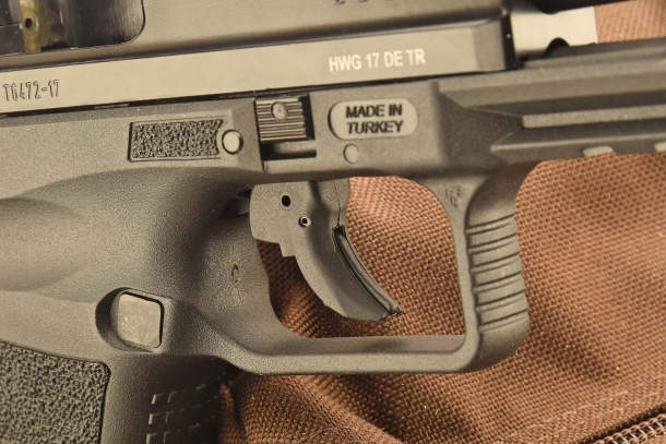 A close-up of the Canik TP9 SF trigger and its safety